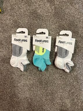 Three pairs Feetures Elite M light cushion socks